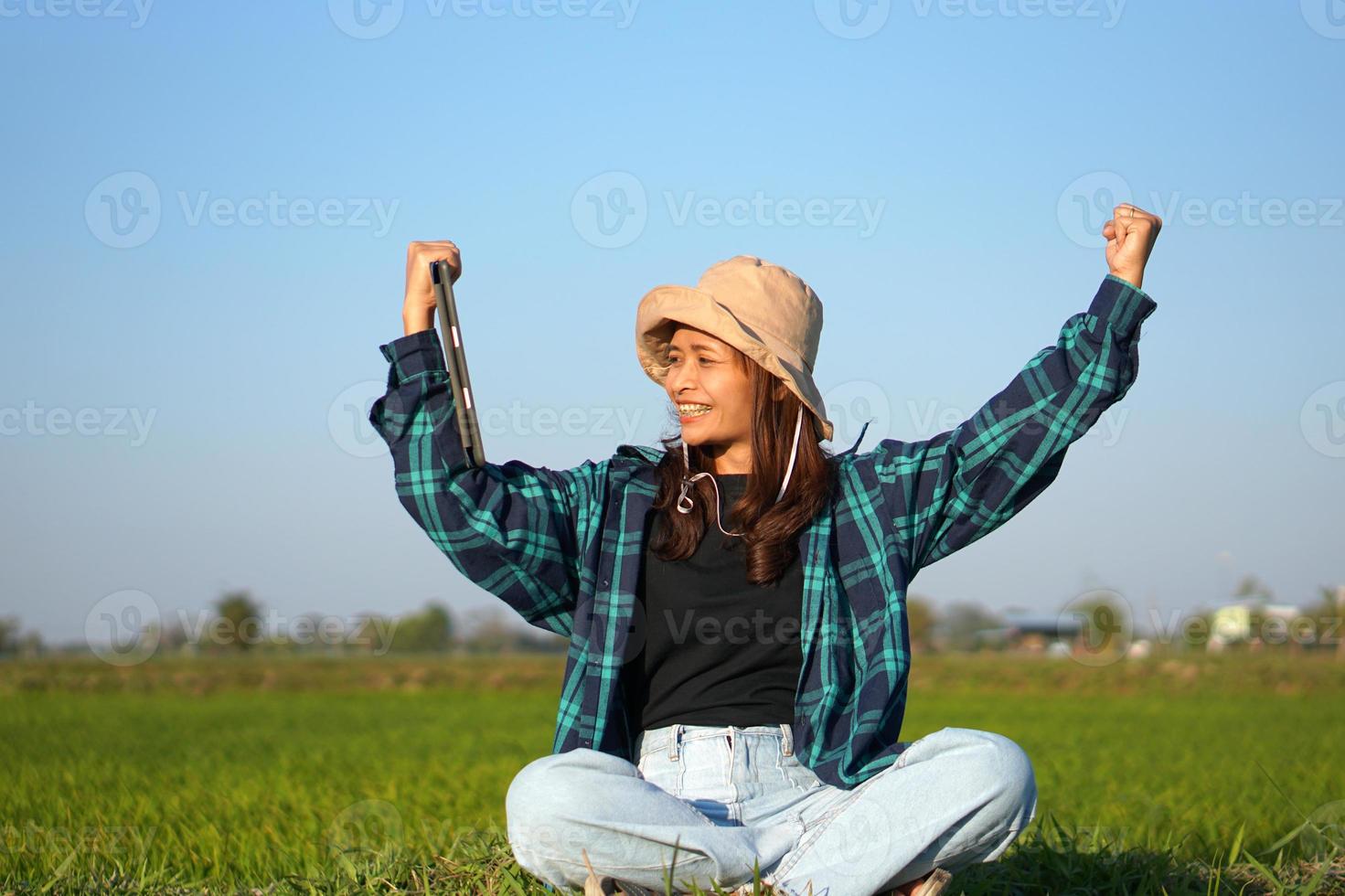 Asian female farmer delighted with rice growth target. Computer analysis photo