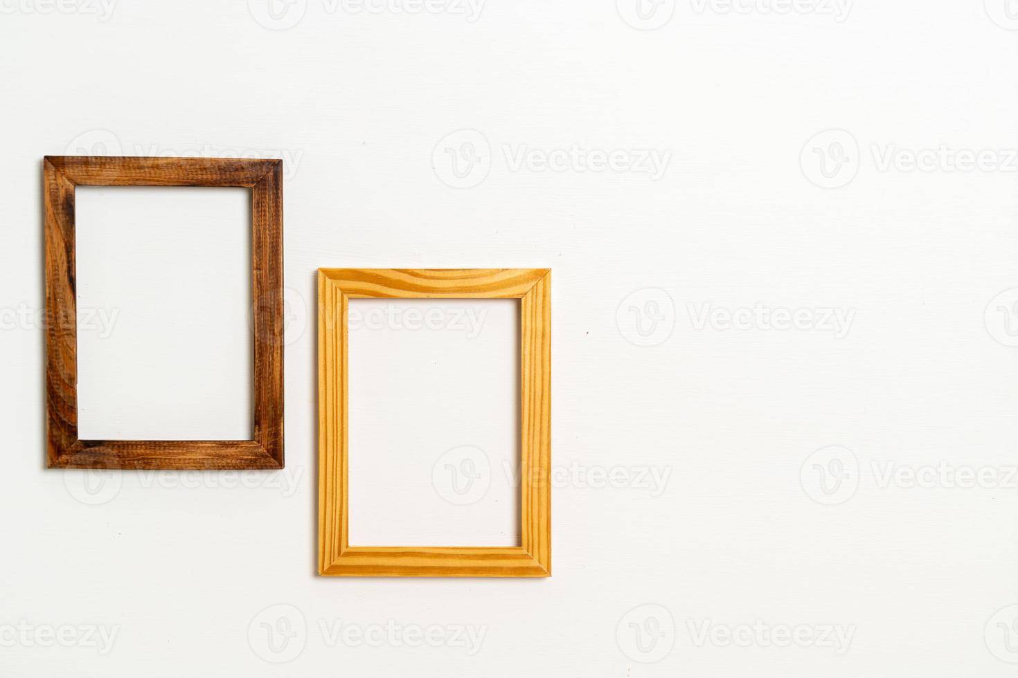 empty picture frame on white wall background photo