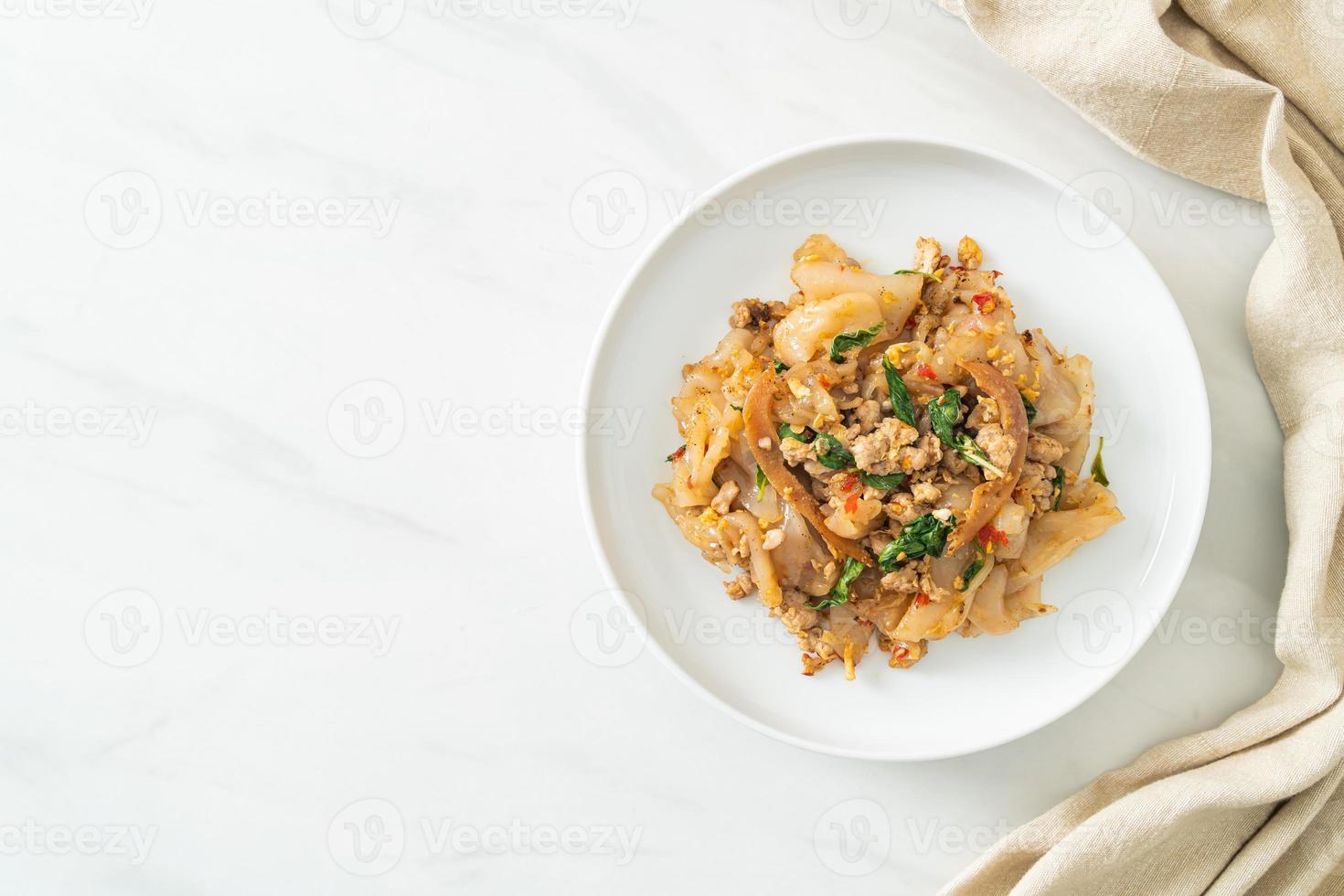 Stir-fried noodle with minced chicken and basil photo