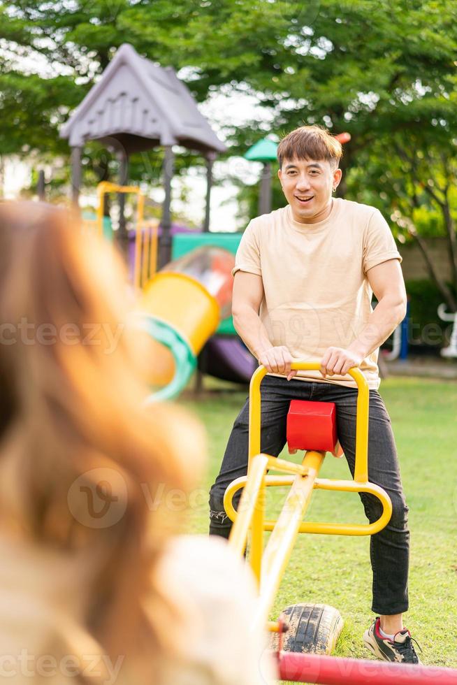 Asian couple love play seesaw photo