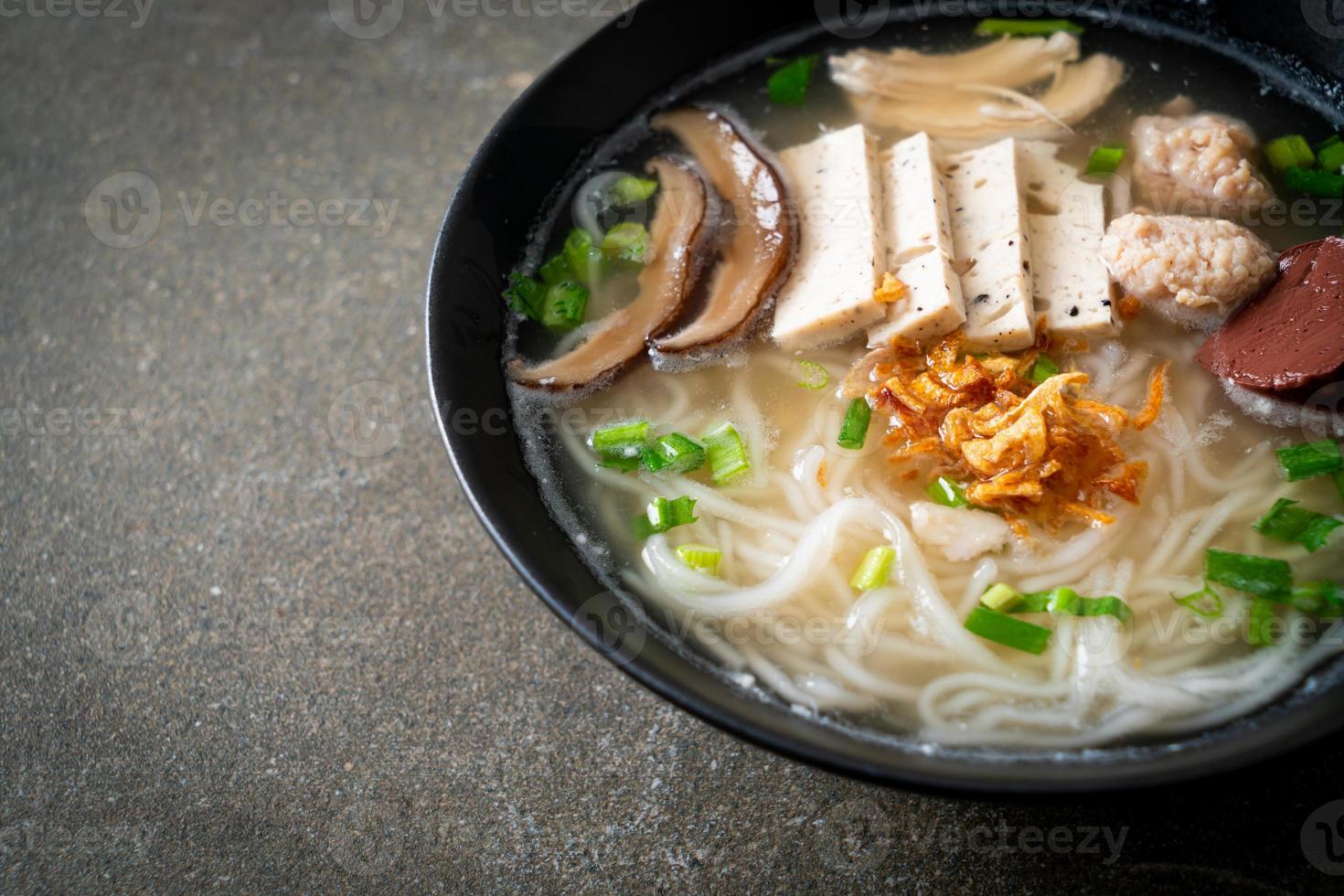 Vietnamese Rice Noodles Soup with Vietnamese Sausage served vegetables and crispy onion photo