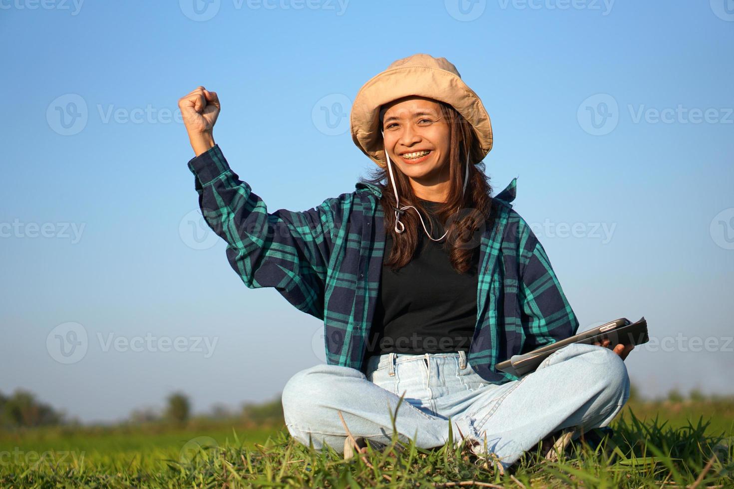 Asian female farmer delighted with rice growth target. Computer analysis photo