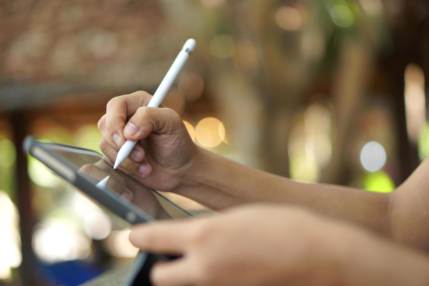 Female hand working looking at plan on computer in cafe photo