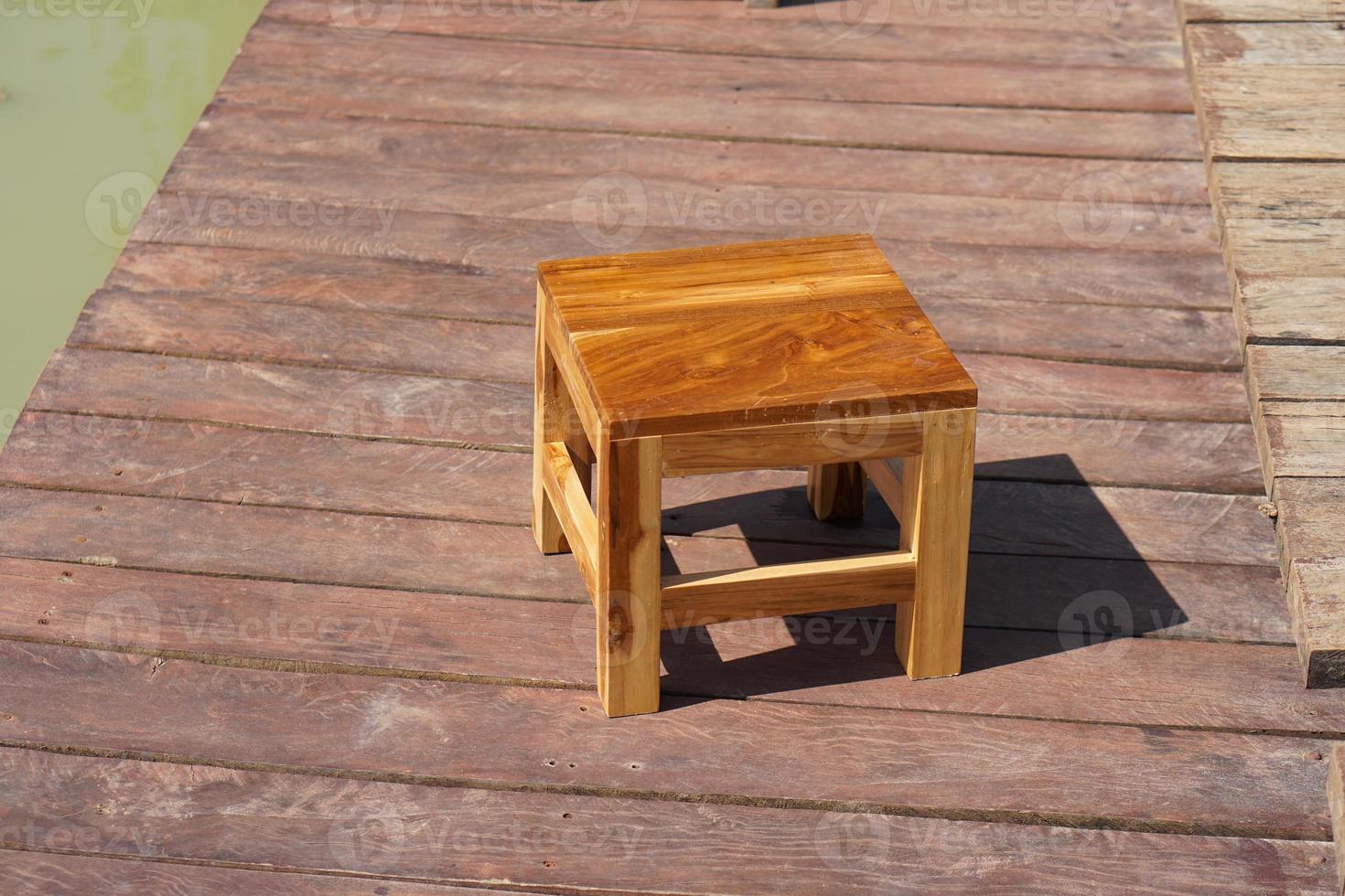 Wooden chairs on the wooden floor for sitting by the pool. photo