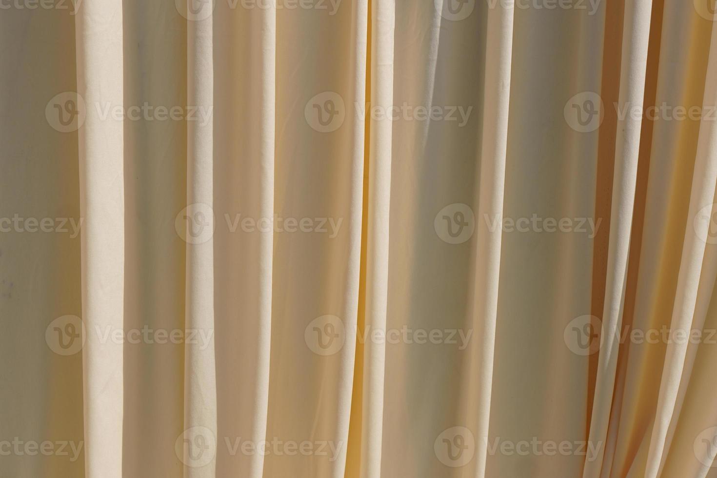 Background Yellow curtains lined in waves. photo