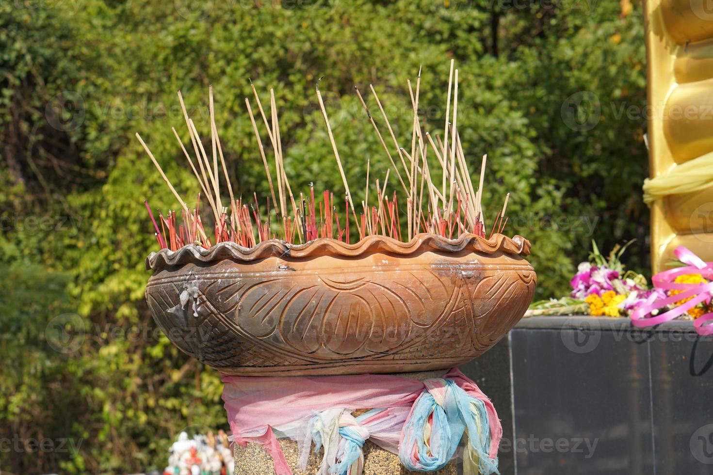 Clay pots with many incense sticks to worship the Buddha photo