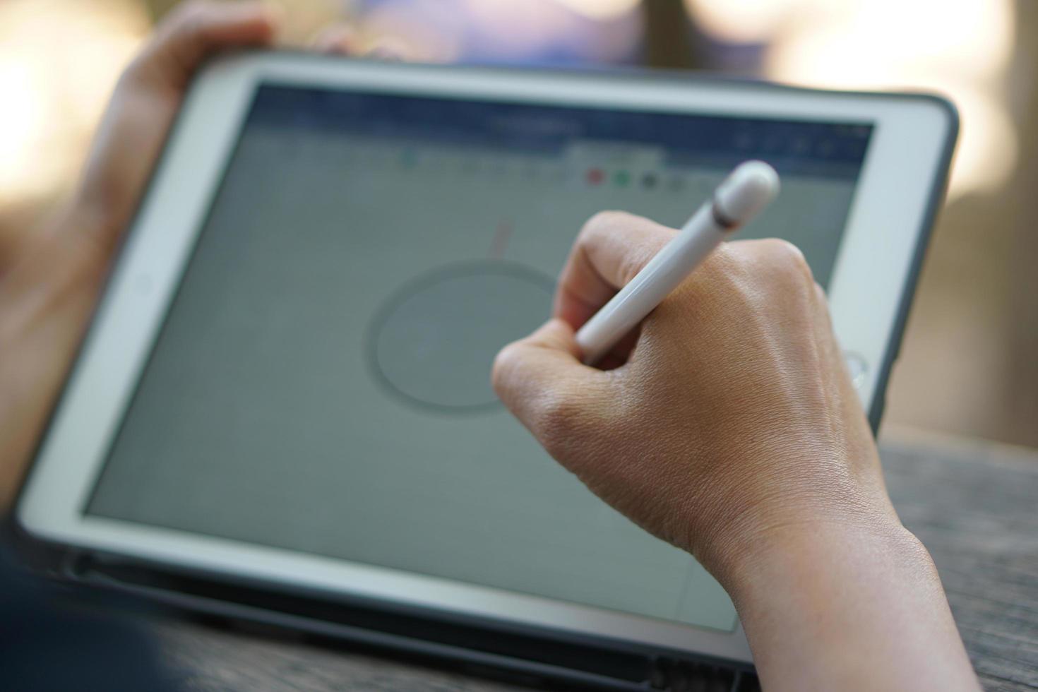 Female hand working looking at plan on computer in cafe photo