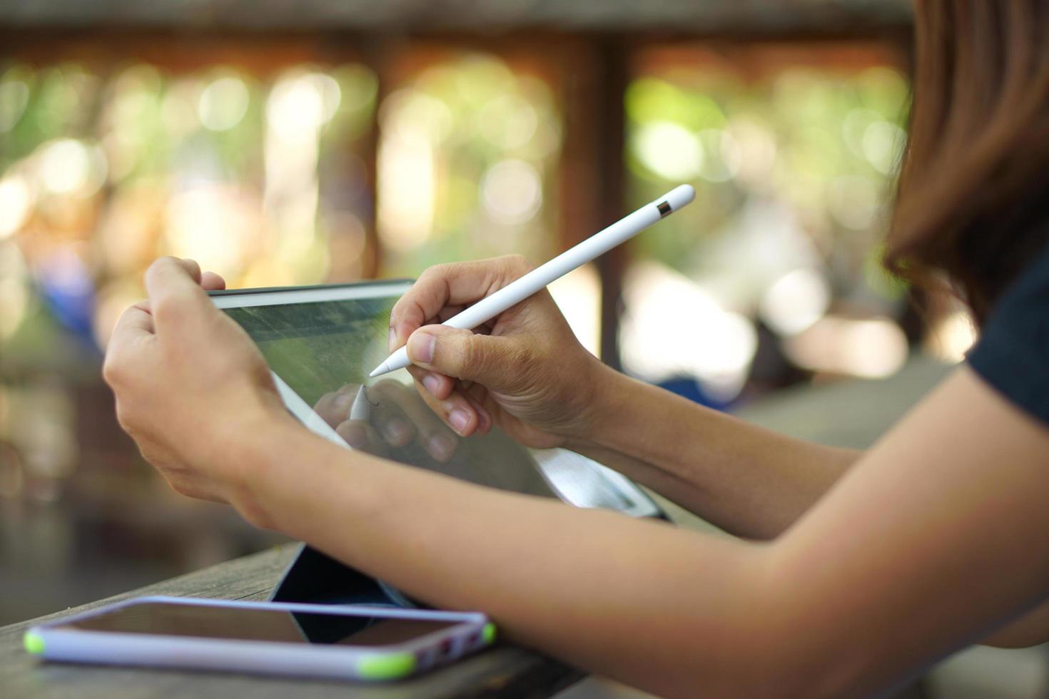 Female hand working looking at plan on computer in cafe photo