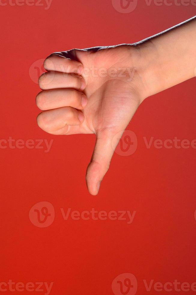 Close-up of a hand with a fingernail up of an isolated on a red background photo