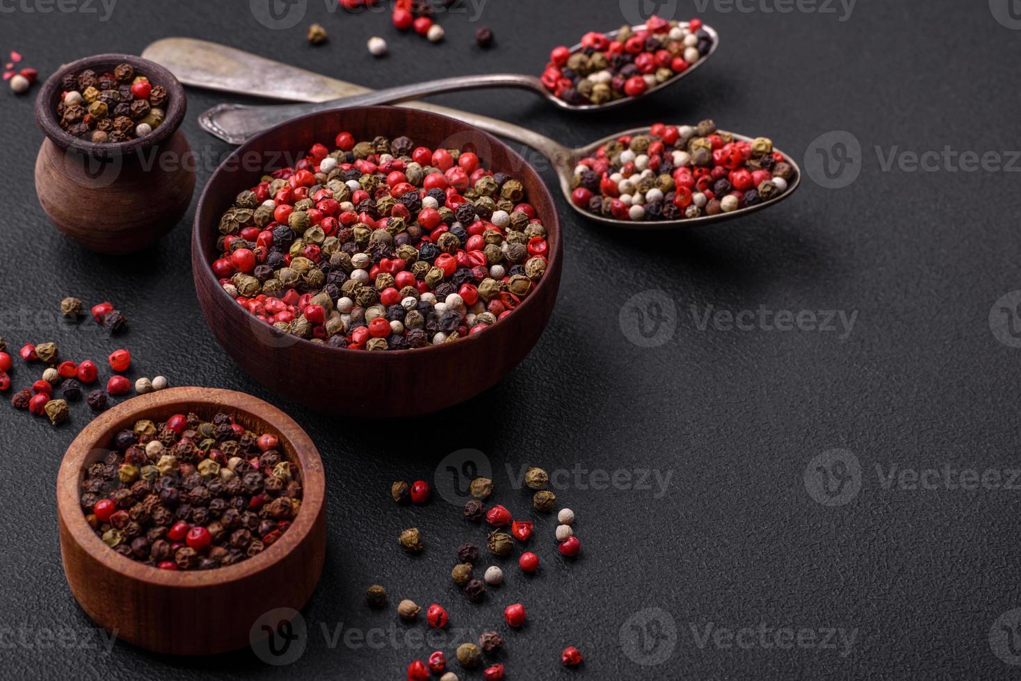 Spice allspice of different colors pink, white, green not ground in a wooden saucer photo