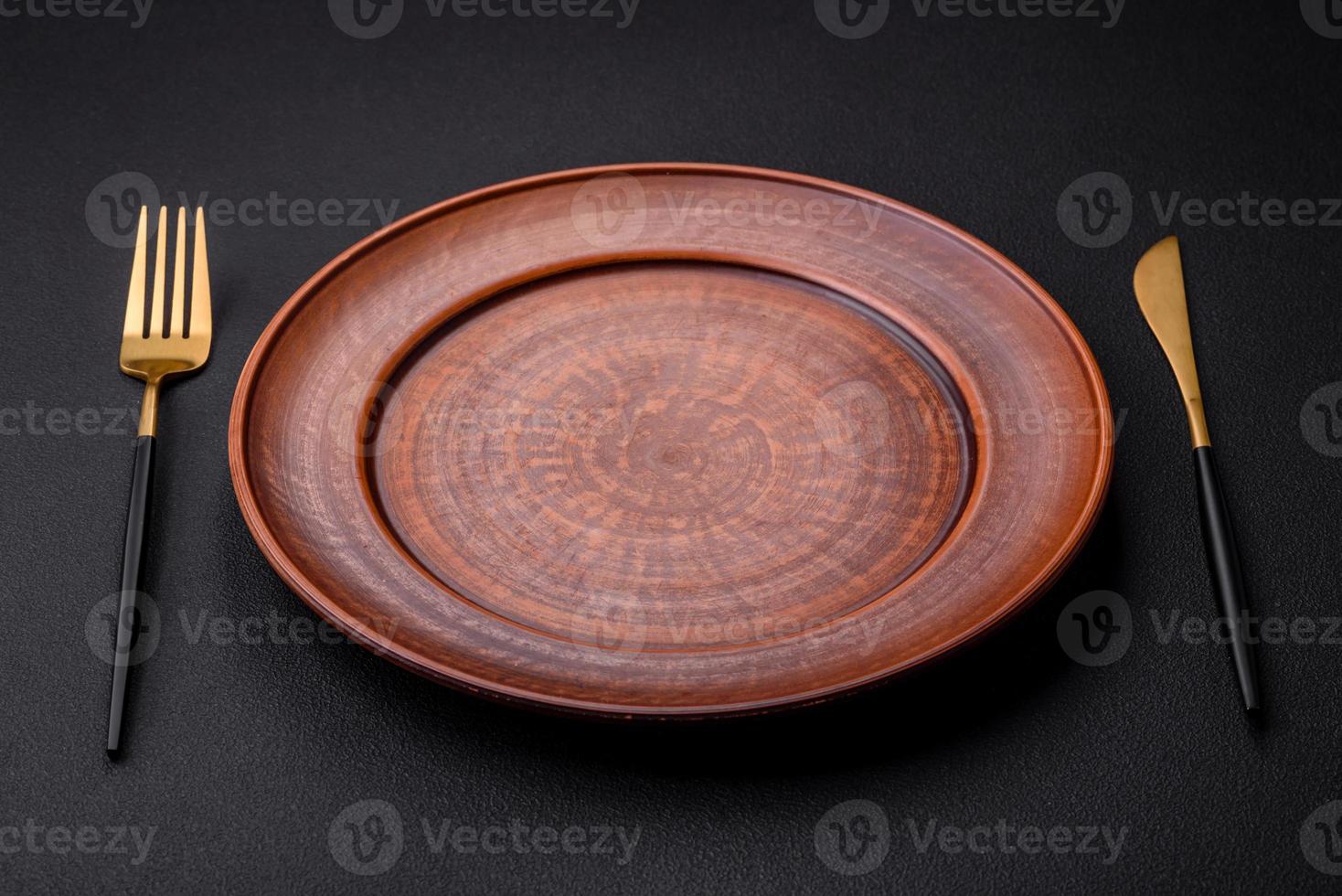 Empty ceramic round plate on dark textured concrete background photo