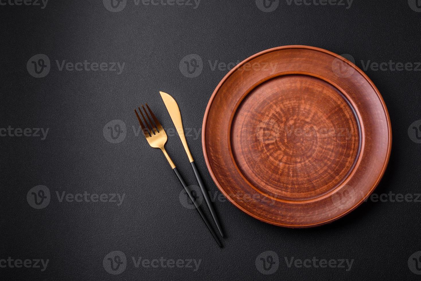 Empty ceramic round plate on dark textured concrete background photo
