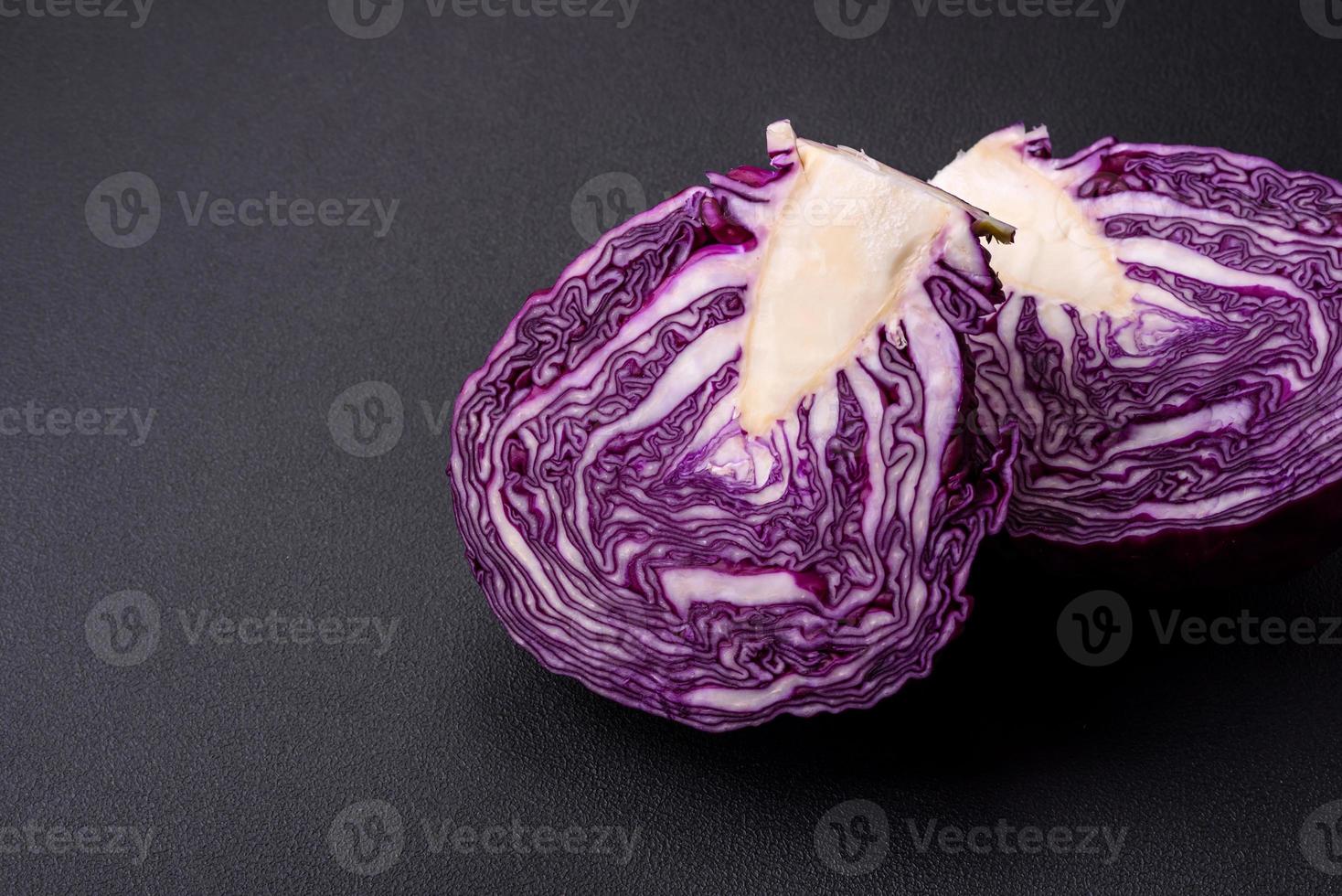 Fresh beautiful red cabbage with textured leaves on a dark concrete background photo