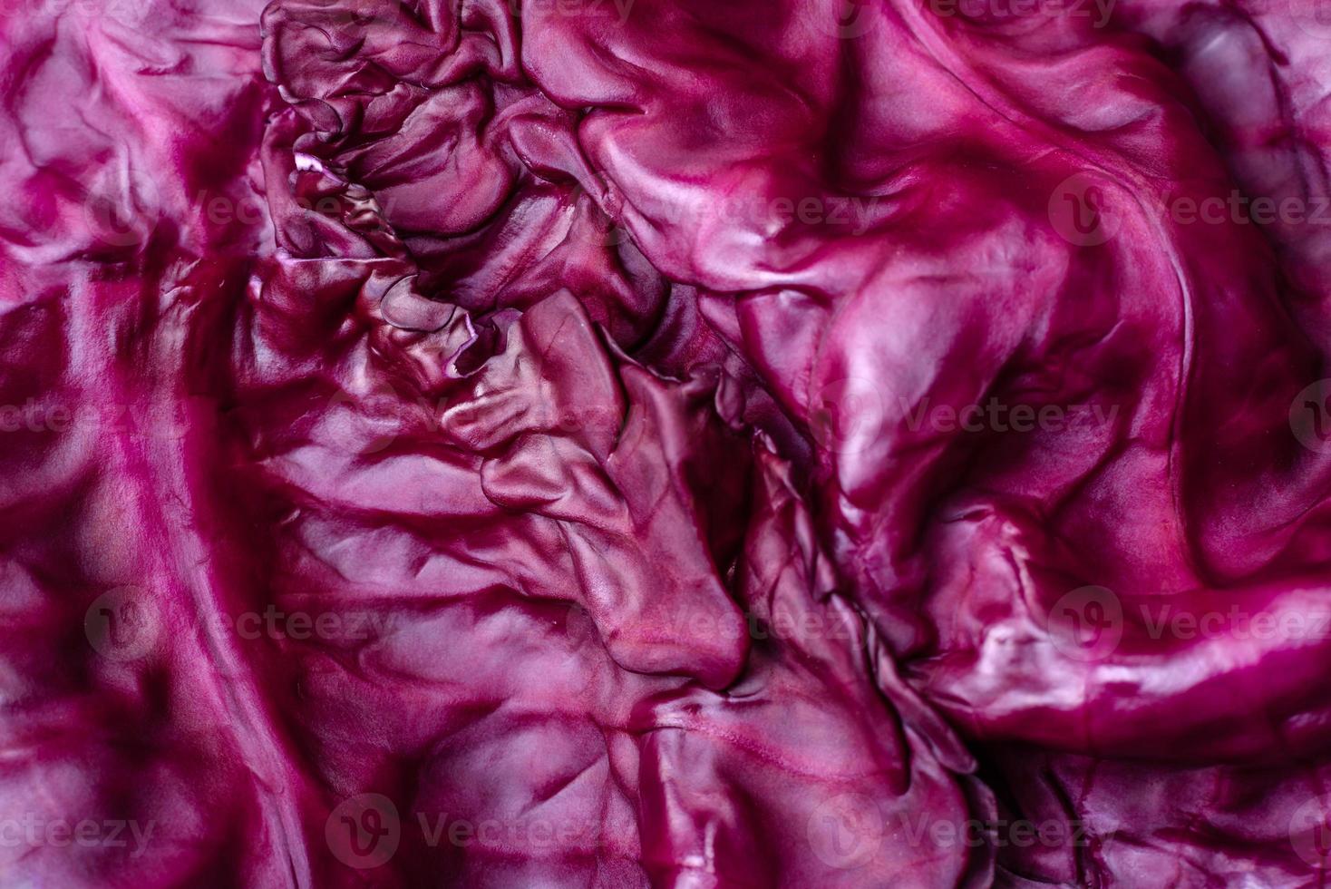 Fresh beautiful red cabbage with textured leaves on a dark concrete background photo