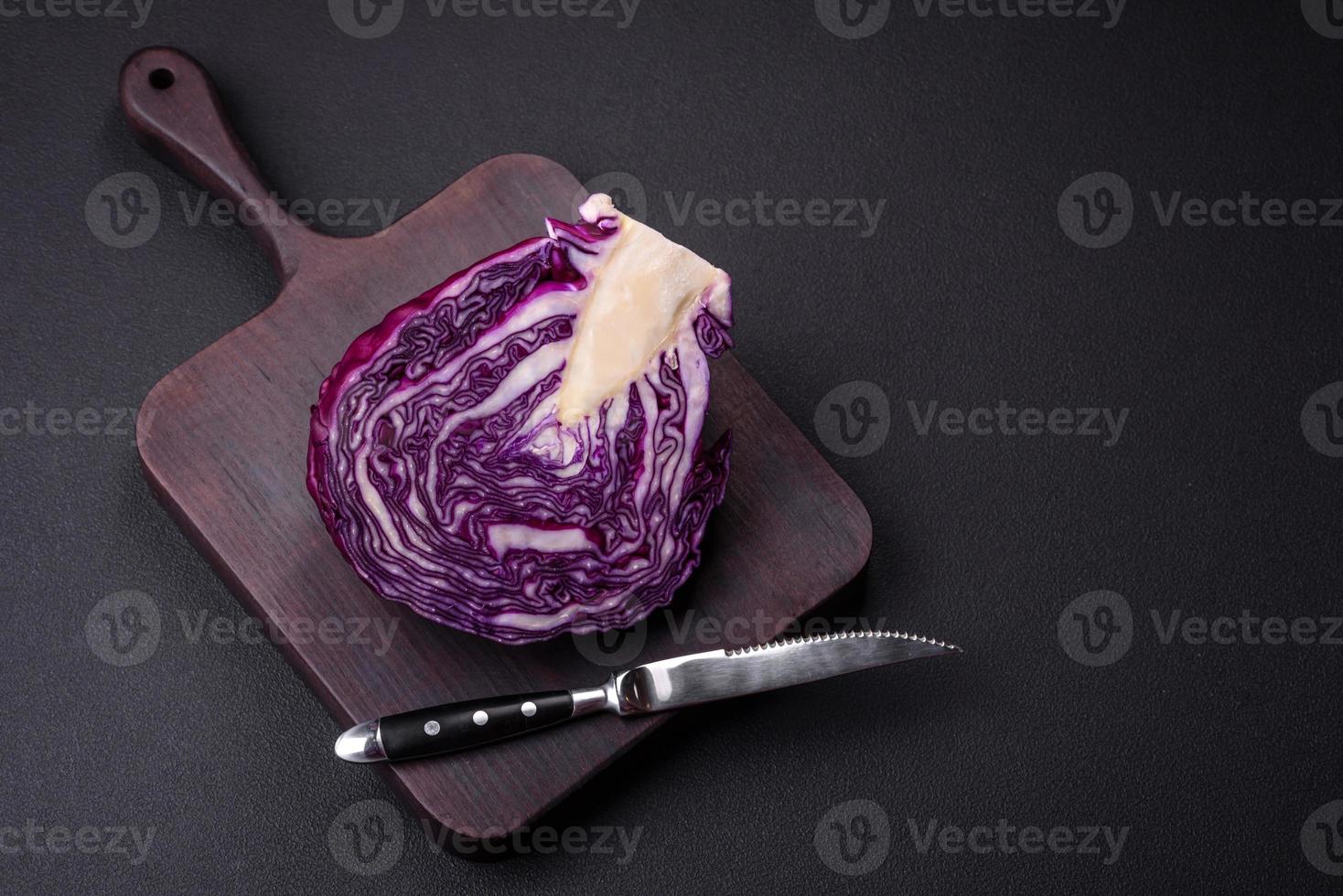 Fresh beautiful red cabbage with textured leaves on a dark concrete background photo