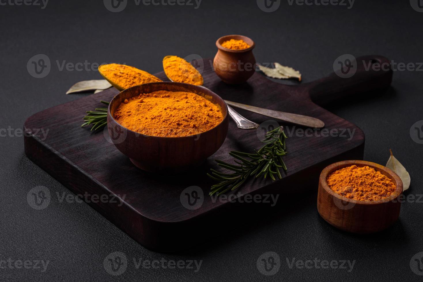 Bright yellow turmeric or curry spice for Asian food preparation photo