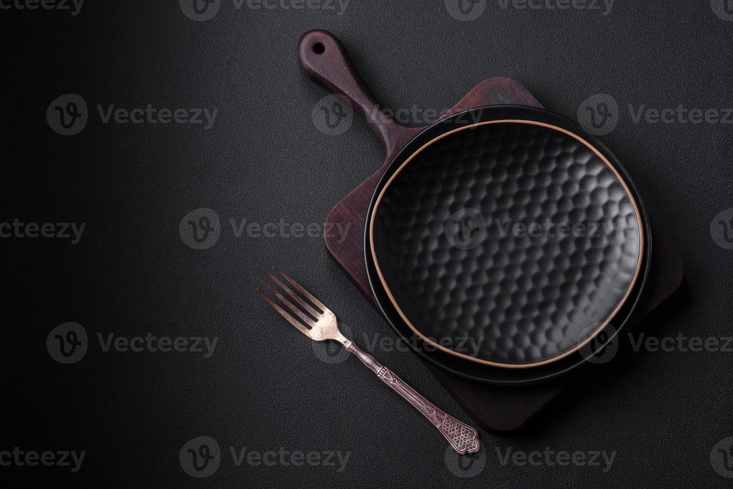Empty ceramic round plate on dark textured concrete background photo
