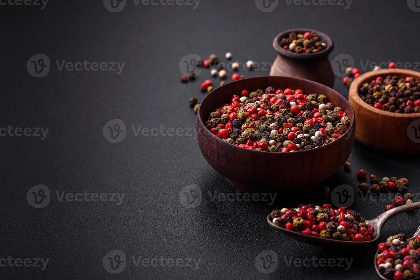 Spice allspice of different colors pink, white, green not ground in a wooden saucer photo