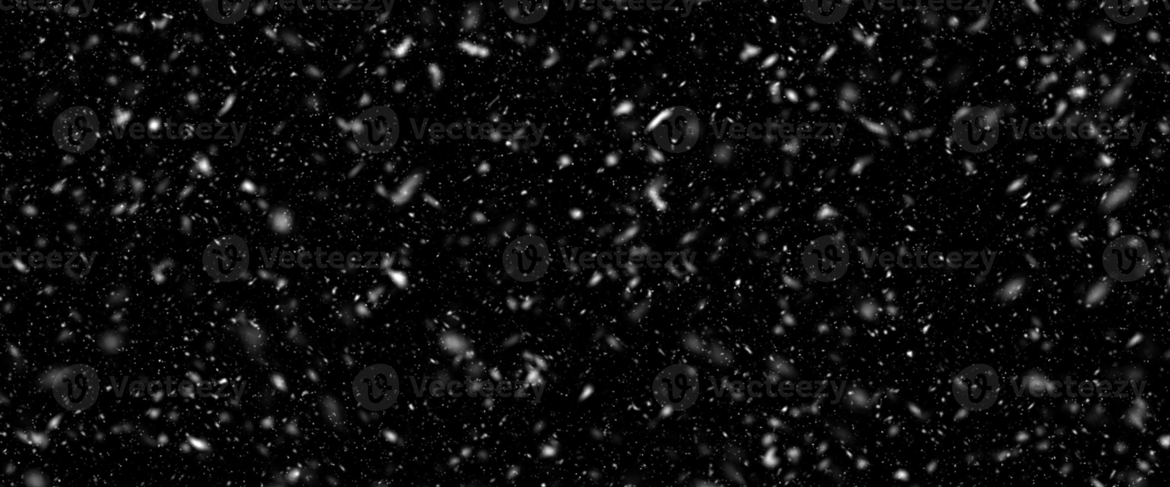 Snowfall bokeh on dark foundation. Numerous snowflakes in flying in the air. Winte night snowfall and snowstorm of snow at. Obscure bokeh light impact innovative foundation. photo