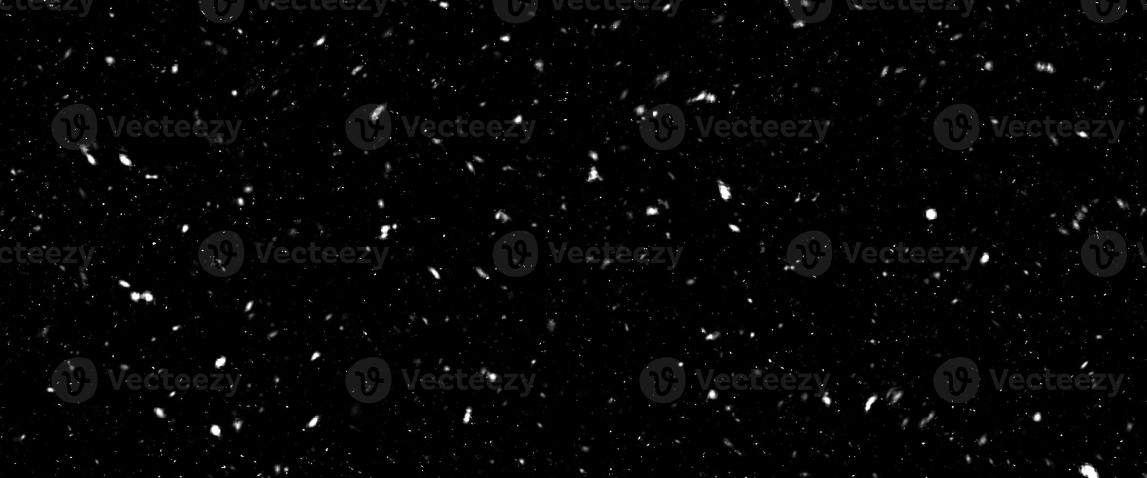 Falling snow isolated on black background. Falling snow at night. Bokeh lights on black background, flying snowflakes in the air. Winter weather. Overlay texture. photo