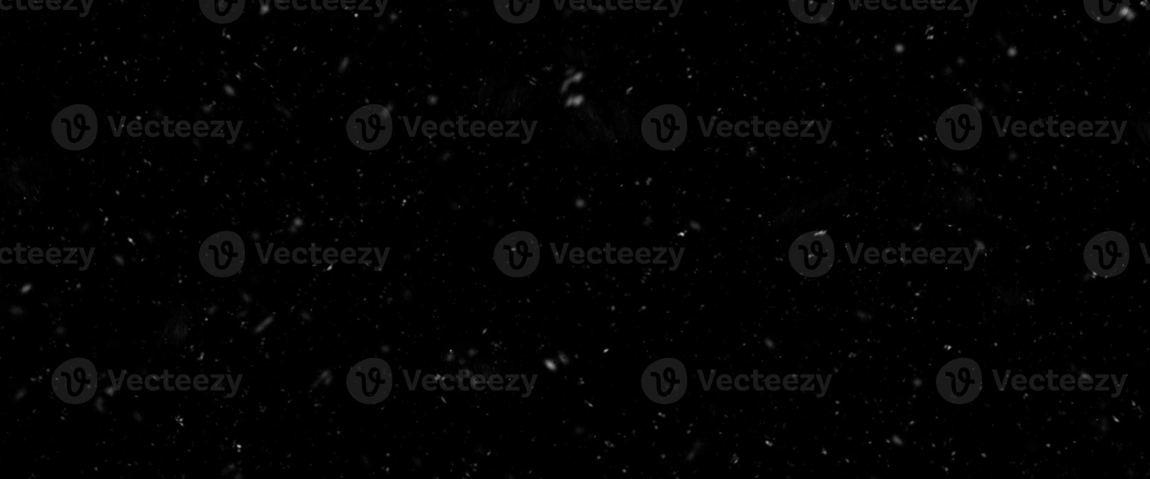 Falling snow isolated on black background. Falling snow at night. Bokeh lights on black background, flying snowflakes in the air. Winter weather. Overlay texture. photo
