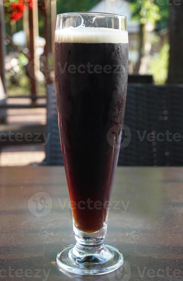 Glass of Dark Beer on a Table photo