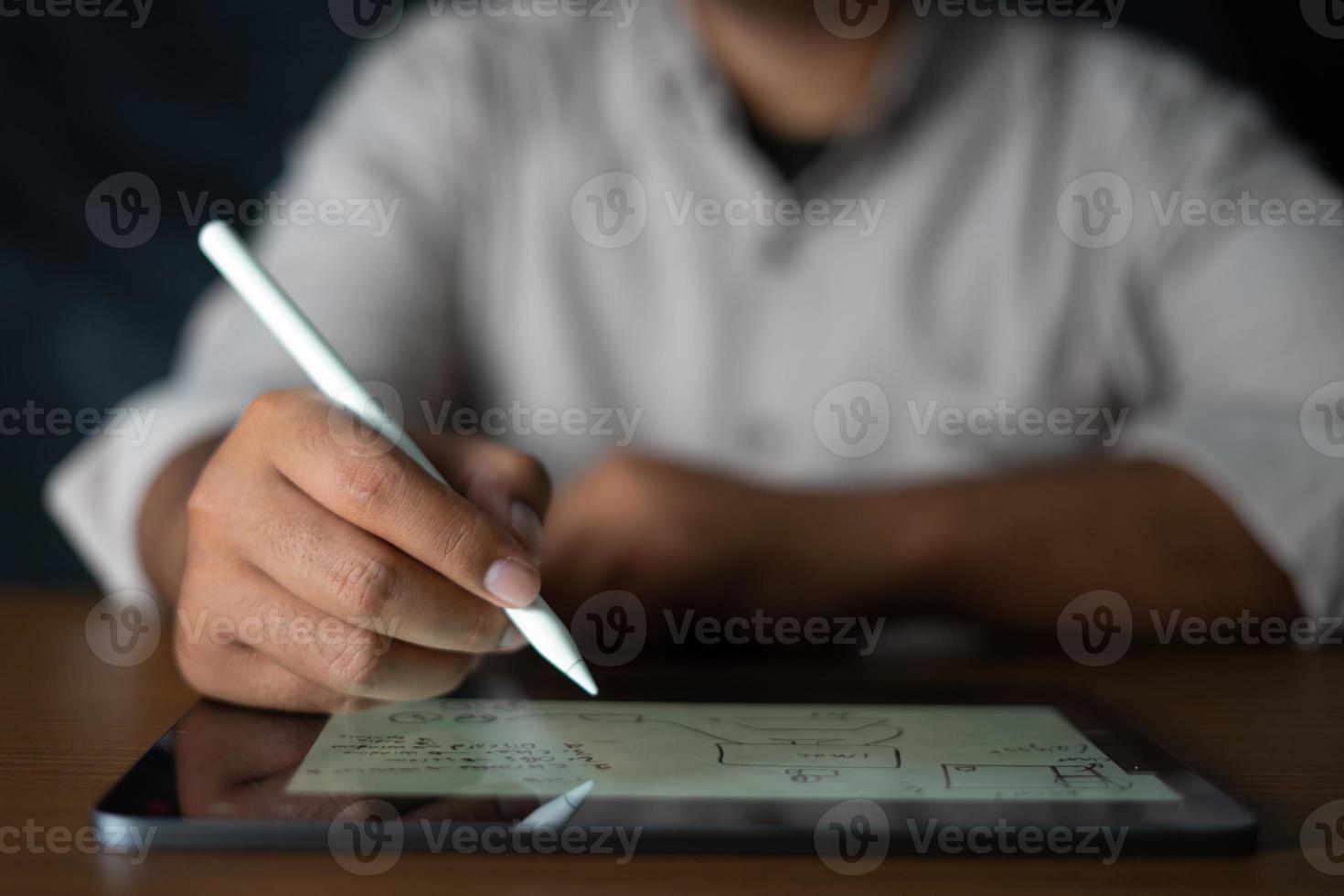 Man holding a digital pencil for planners and analyzing business strategies photo