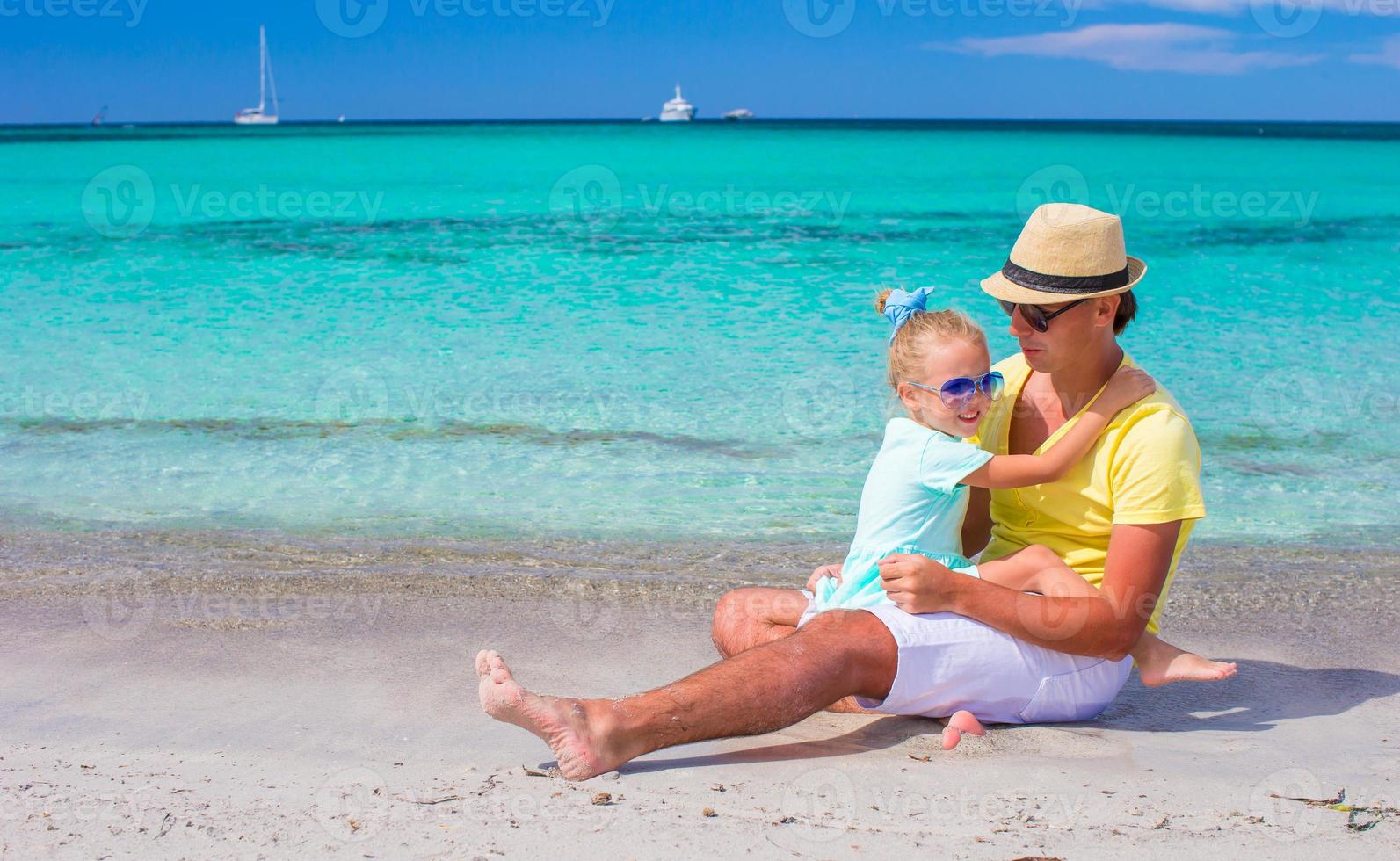 Dad with kid having fun during tropical beach vacation photo