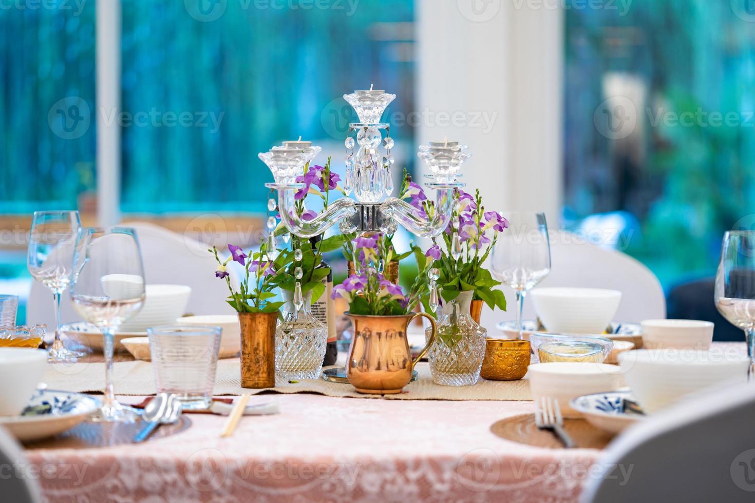 the luxury dinner set on the table with green and pink theme. photo