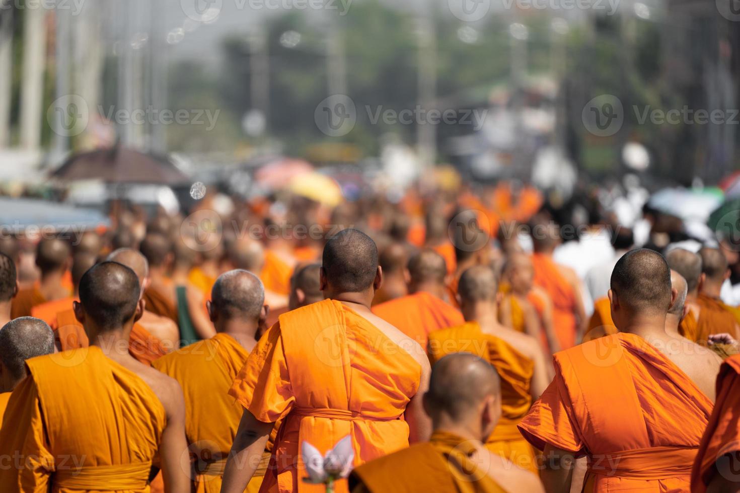 a group of monk on pilgrimage walk on the street at noon time, Thailand. photo