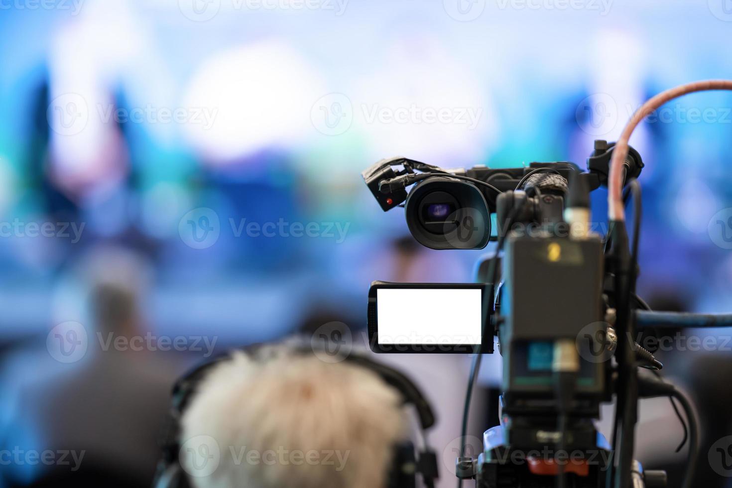 Asian man Videographer in backside are shooing and recording video in Speech event on the stage. photo