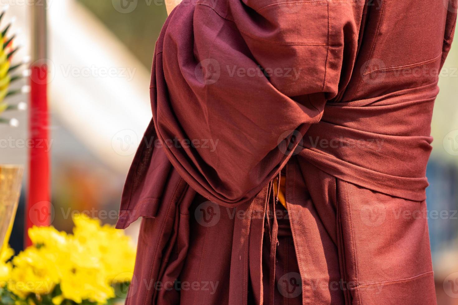 Close up Asian Monk wears red brown cloth for Northern Thailand Traditional Event. photo