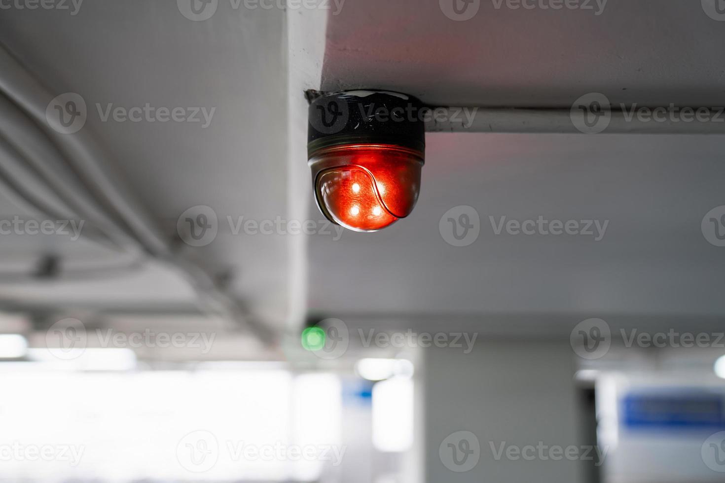 Close up to overhead LED status light of car parking in department store building parking. photo