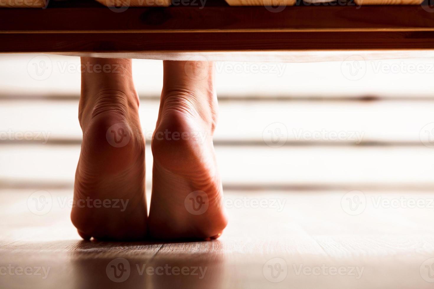 Closeup shot of dangling female bare feet photo