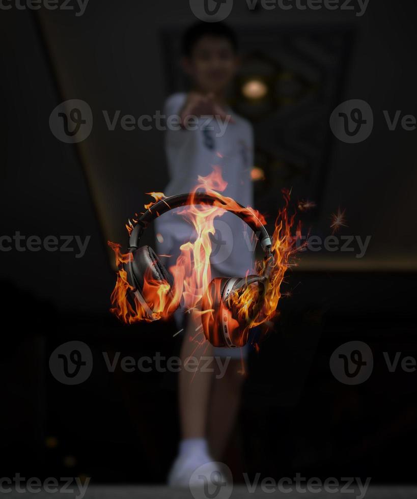 Headphone is floating and burning on the air in front of the boy, Conceptual image of hot and energy music, listen with the headphone photo