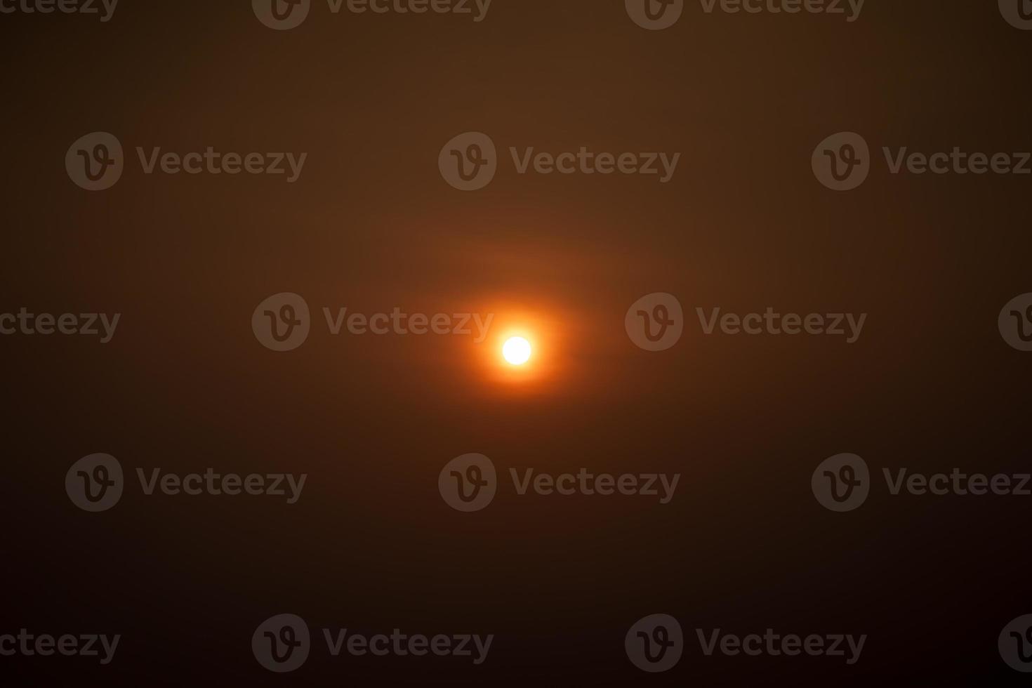 close up to the sun in center of minimal image in runrise time without any cloud around it. photo