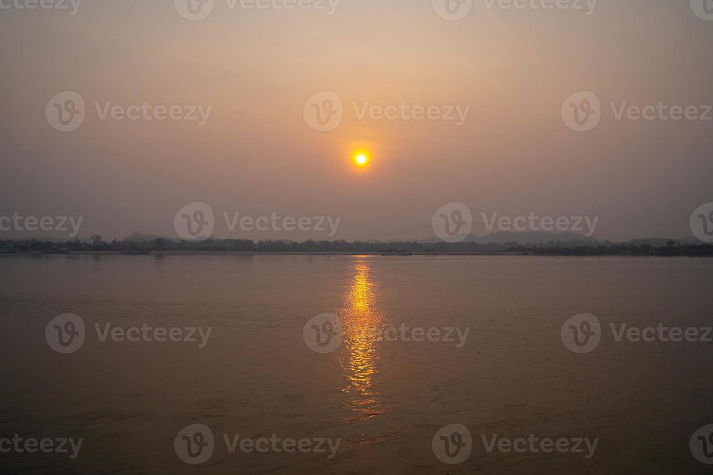 The Sunrise environment at Mekong River, shoot image from Thailand side to Laos country with sunlight reflexion on surface river. photo