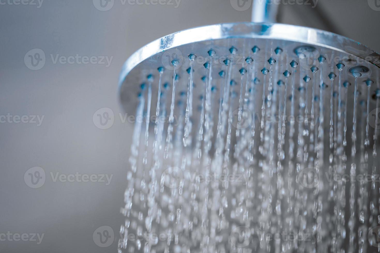 Close up to Outdoor shower head for the bath and showering cold water to body before jumping in the resort pool. photo