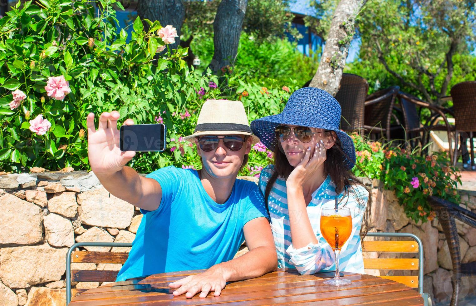 Young couple relaxing in outdoor cafe photo