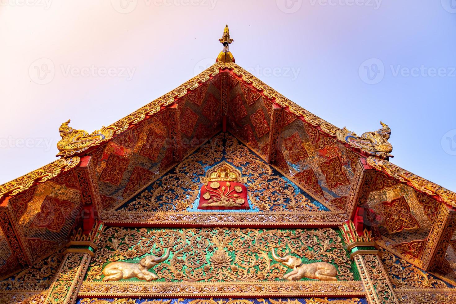 A front roof of Buddhist Temple at Wat Phra That Doi Tung, a famous Temple and Buddhism place. It's settled on the mountain in Chiang Rai province, north of Thailand. photo