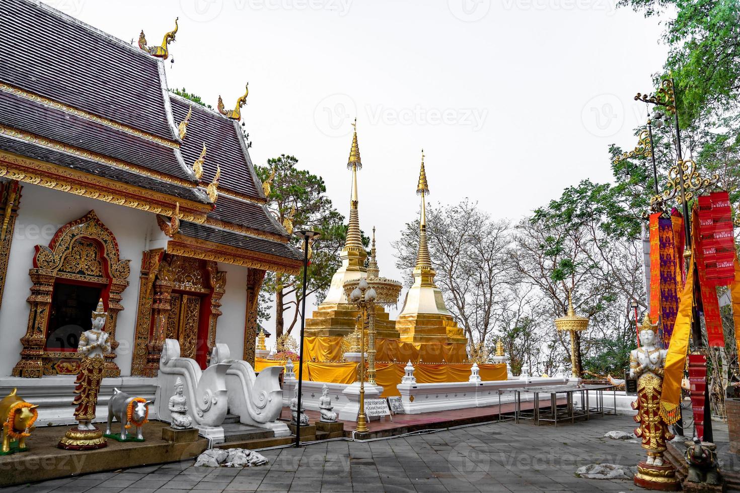 Wat Phra That Doi Tung, famous temple north of Thailand. Thai Wording at center-bottom of image that left side means PLEASE TAKE OFF YOUR SHOES and right side means LADY NO ENTRY. photo