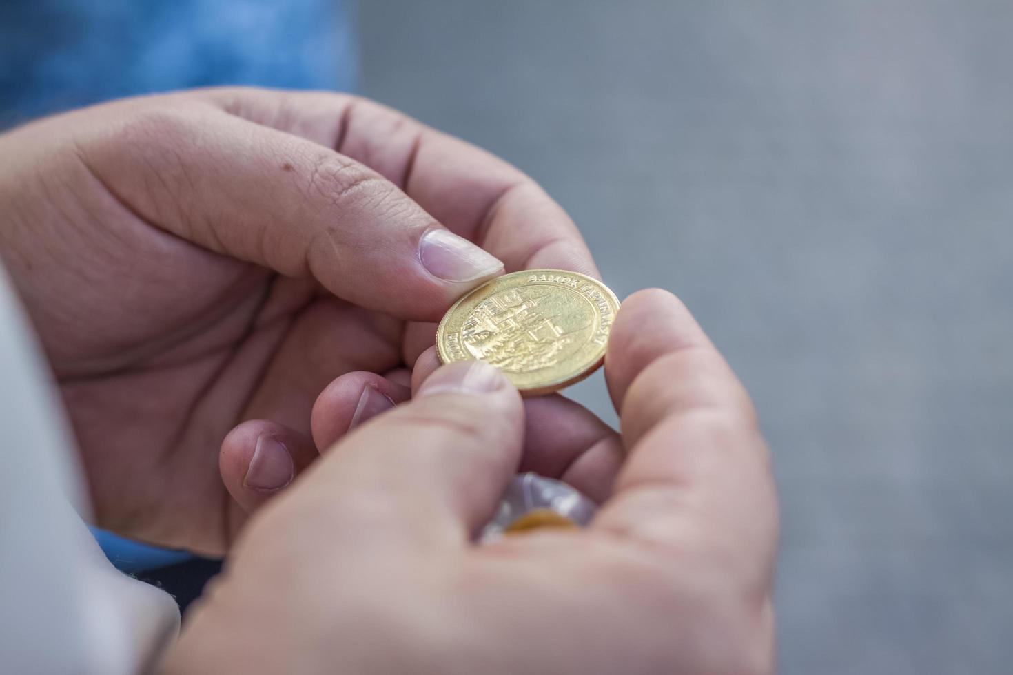 2022-08-16 Russia, Samara, Tourist center Castle Garibaldi in the village of Khryashchevka, Samara region. Newly minted commemorative coin in hand photo