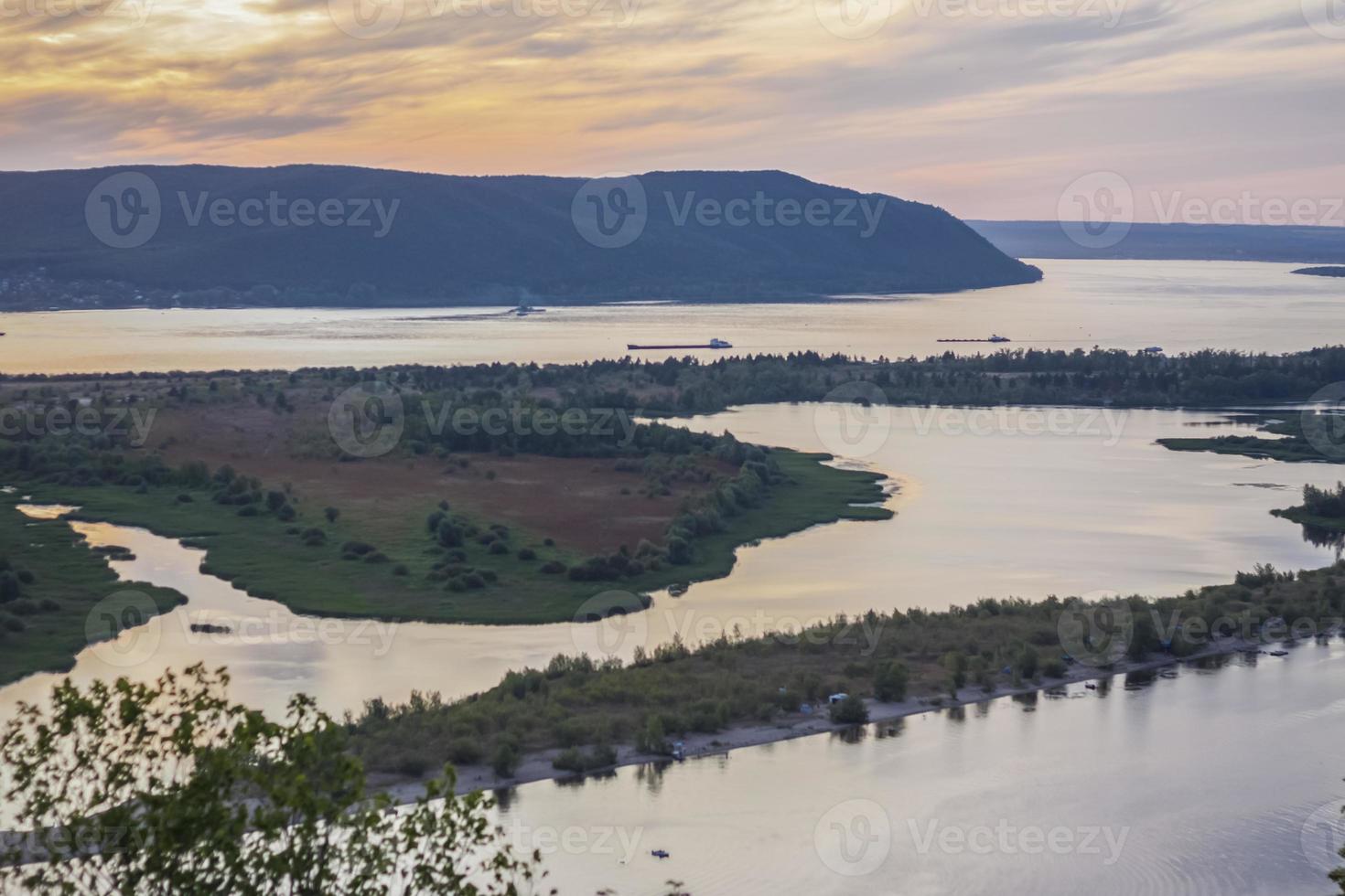 sunset on the Volga river. Natural landscape. reflection, blue sky and yellow sunlight. landscape during sunset. photo