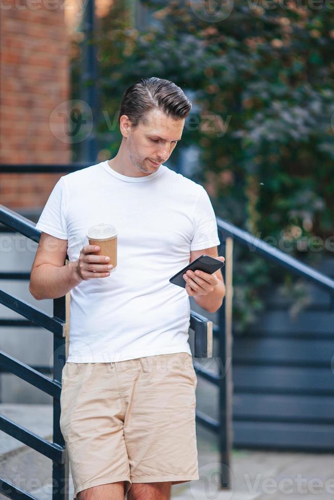 Young man drinking coffee in the city outdoors 18831651 Stock Photo at Vecteezy