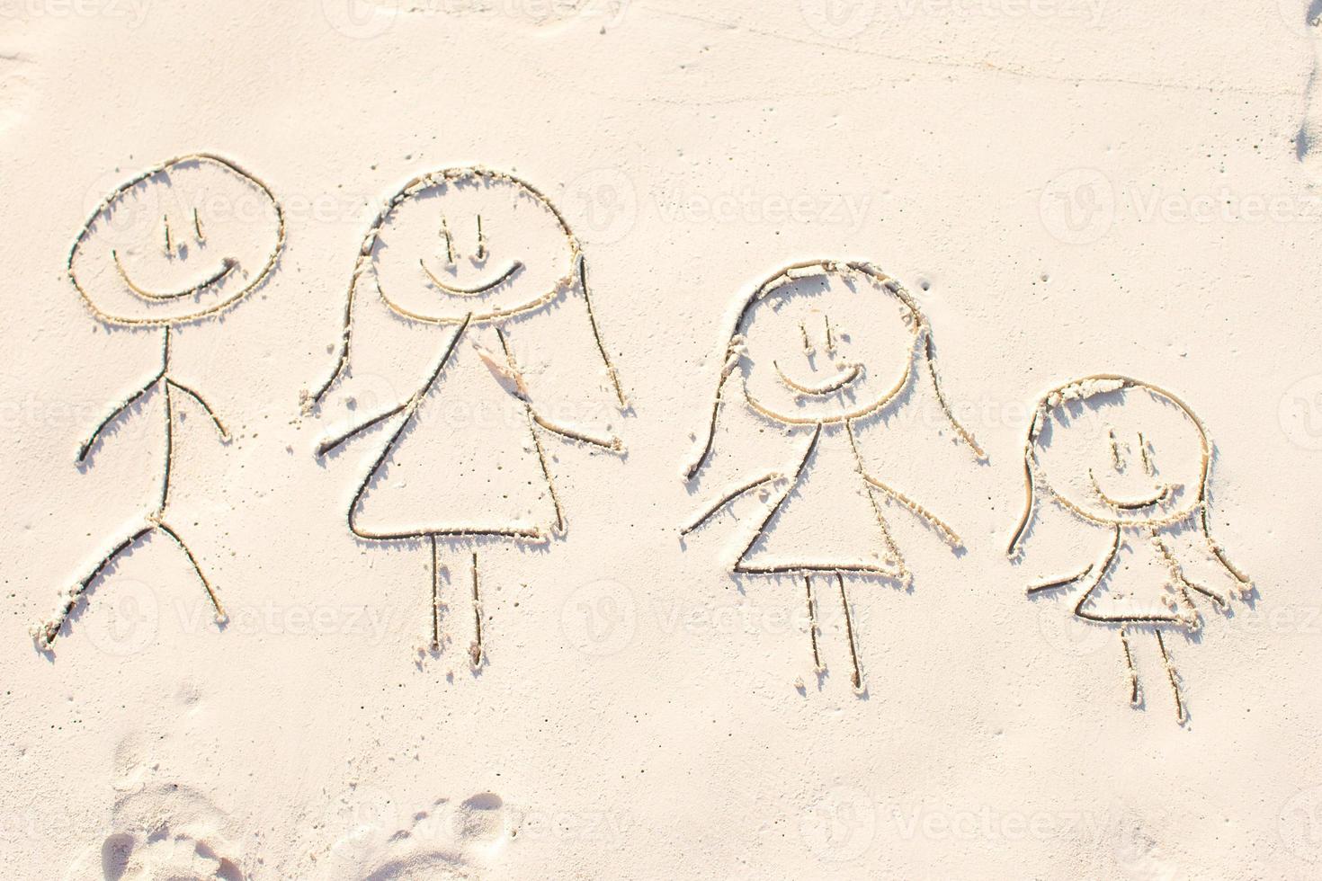 Family symbol drawn on beach white sand photo