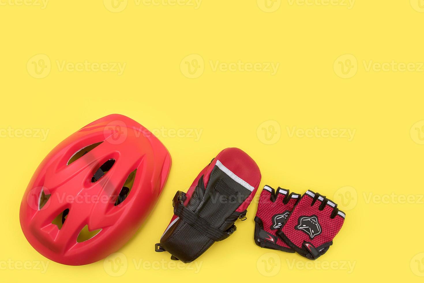 cyclist accessories on yellow background - helmet, bike bag, gloves with copyspace photo