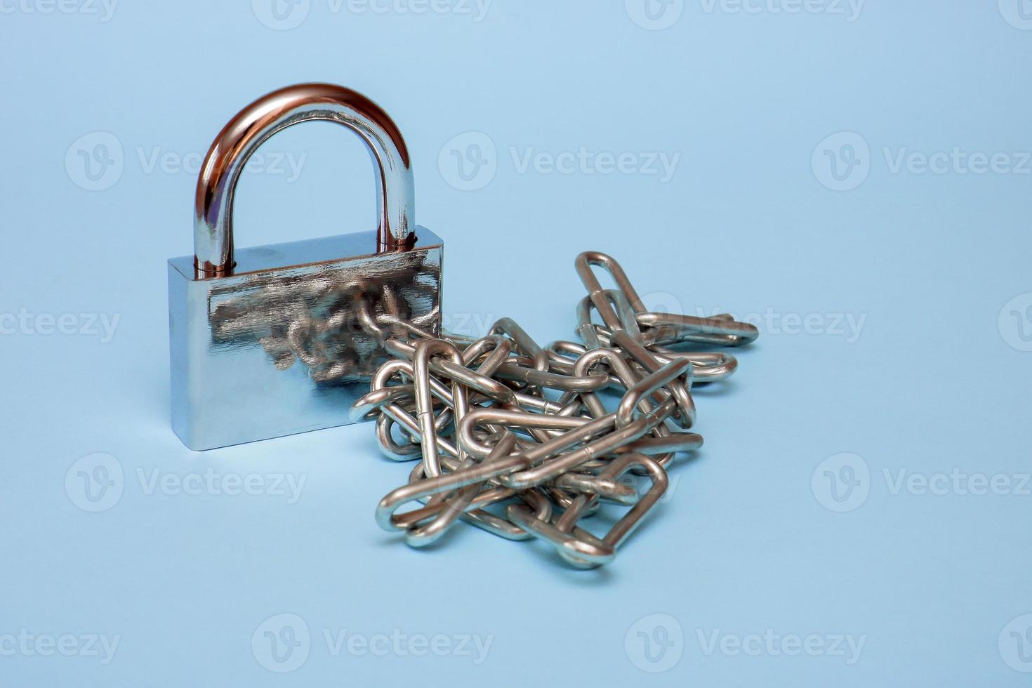 padlock with chain on blue background photo