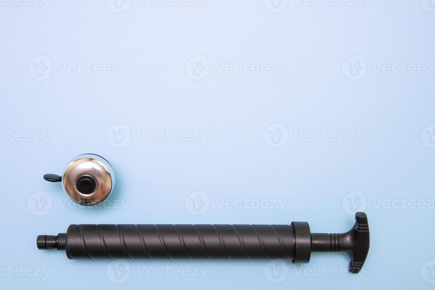 bicycle pump and bell on blue background with copy space photo