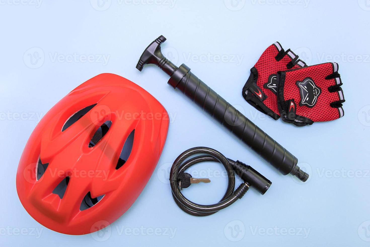 bicycle accessories - helmet, pump, gloves, lock on a blue background photo