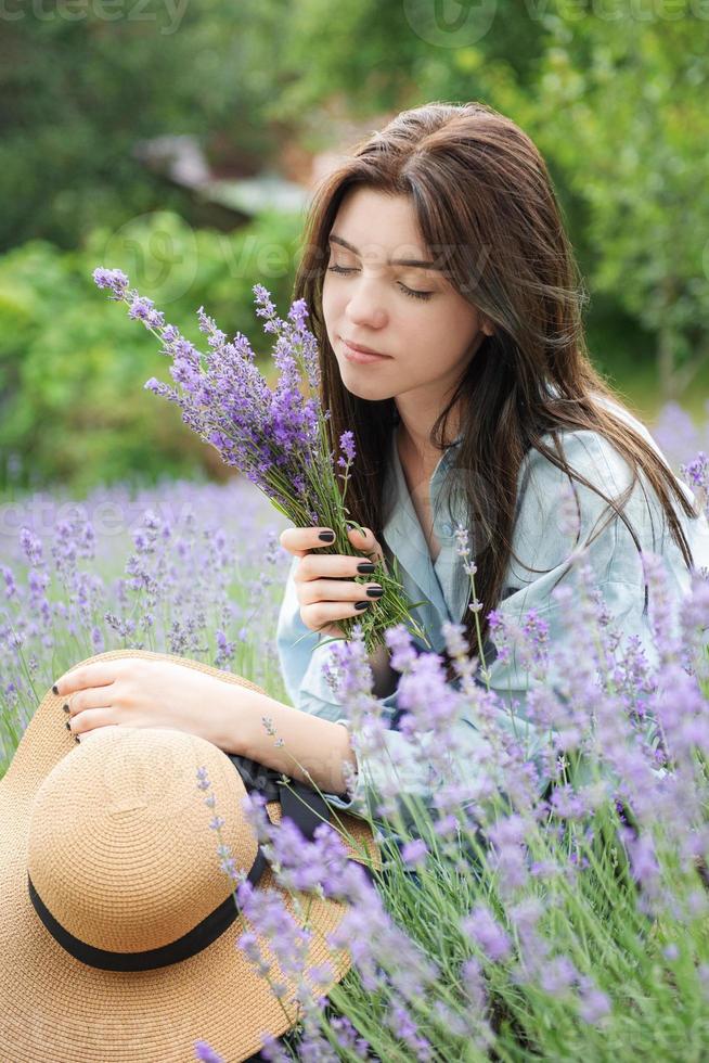 Beautiful young girl on lavender field. photo